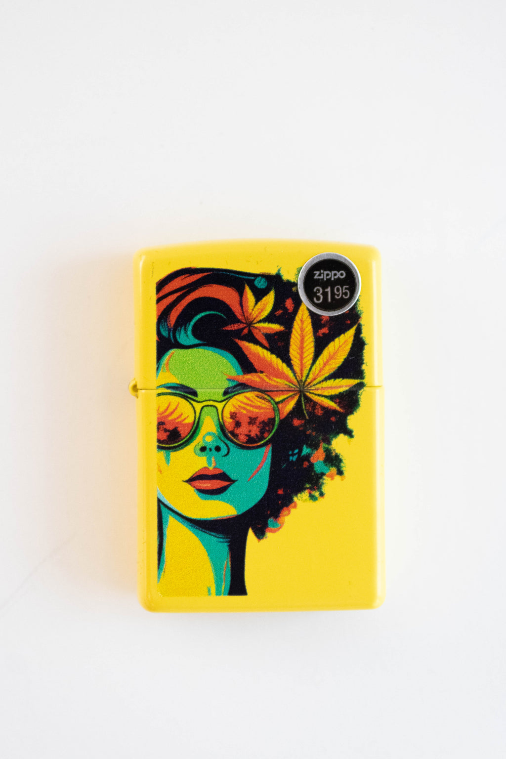 Zippo lighter featuring blazing female figure with cannabis leaf design