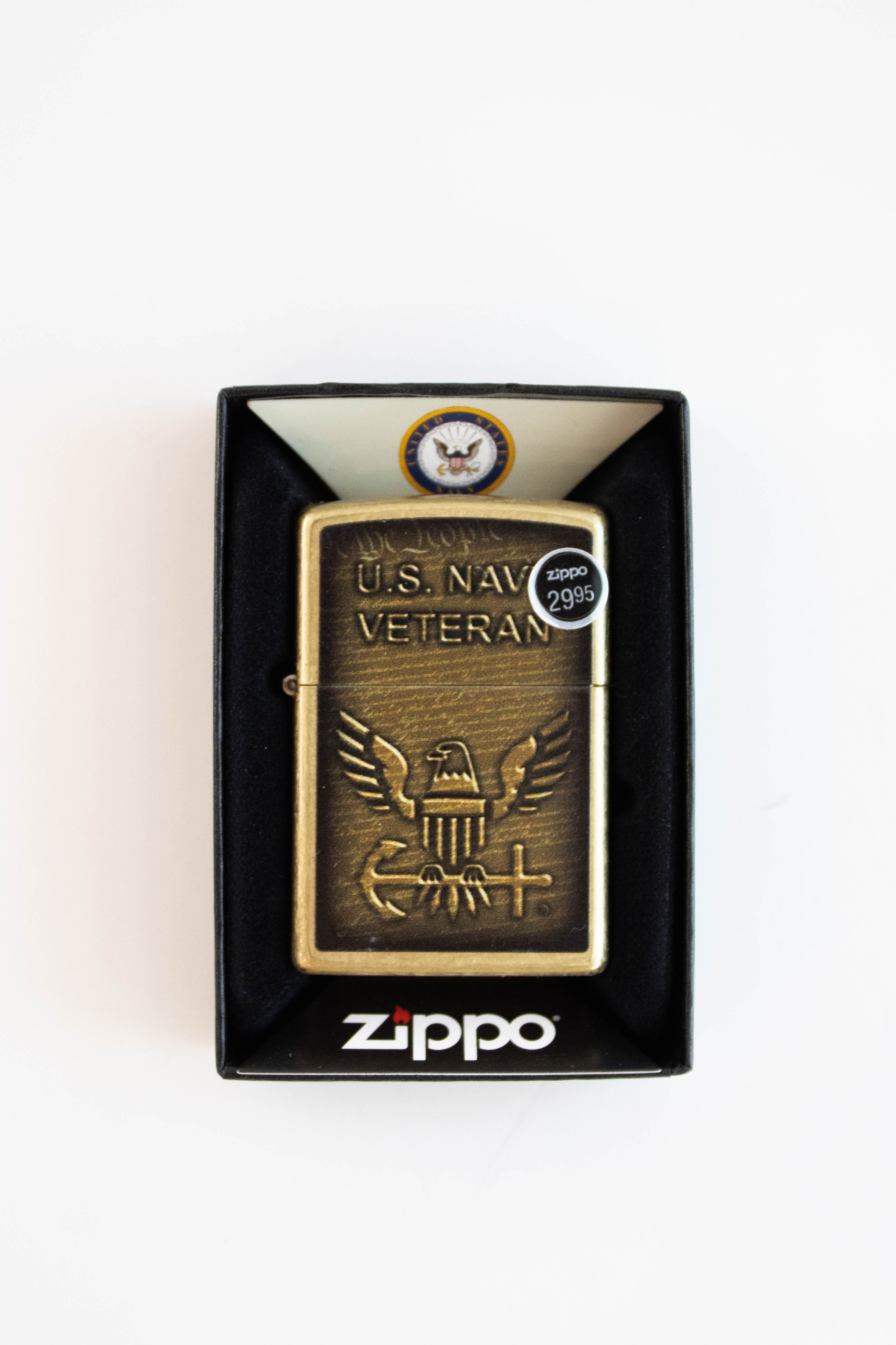 Zippo lighter featuring US Navy Veteran design in street brass finish
